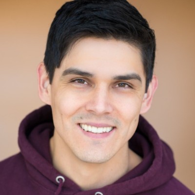 Bryan Bachman, smiling, in a burgundy hoodie